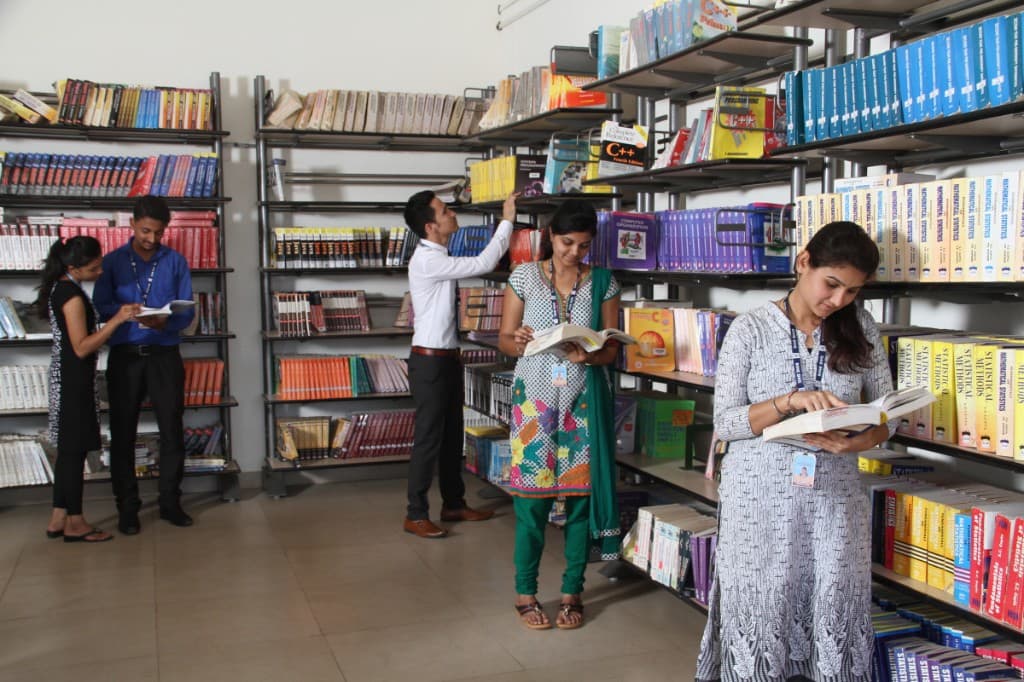 Students browsing books in the BIHE library